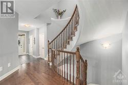 Spacious front foyer with access to the main floor powder room, garage, and stairways to the basement and second floor - 