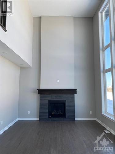 Great Room with 2 Storey Window Wall - 126 Boulonnaius Grove, Kanata, ON - Indoor Photo Showing Living Room With Fireplace