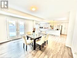 Dining room with french doors and light hardwood / wood-style floors - 