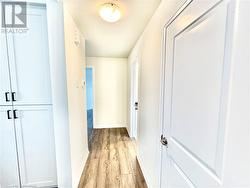 Corridor featuring light hardwood / wood-style floors - 