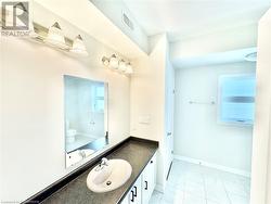 Bathroom featuring vanity, toilet, and a wealth of natural light - 