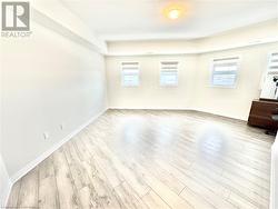 Unfurnished room with plenty of natural light and light wood-type flooring - 