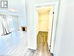 Spacious closet with light wood-type flooring - 