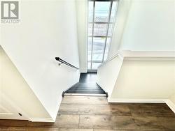 Stairs featuring hardwood / wood-style flooring - 