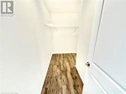 Spacious closet featuring hardwood / wood-style flooring - 