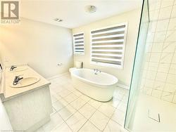 Bathroom featuring vanity and independent shower and bath - 