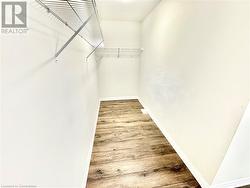 Walk in closet with wood-type flooring - 