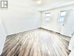 Spare room featuring light wood-type flooring - 