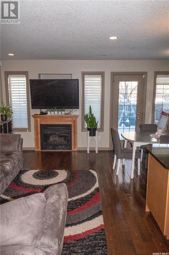 101 2501 Windsor Park Road, Regina, SK - Indoor Photo Showing Living Room With Fireplace