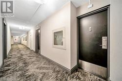 Hallway with a textured ceiling and dark hardwood / wood-style flooring - 