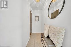 Hallway featuring light tile patterned floors - 