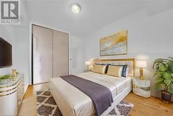 Bedroom with a closet and light hardwood / wood-style floors Virtual Staged - 