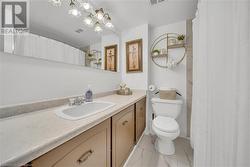 Bathroom featuring toilet and vanity - 