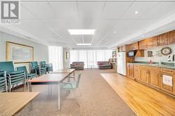 Carpeted dining space featuring sink and a paneled ceiling - 