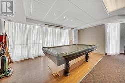 Game room with billiards, hardwood / wood-style flooring, and a drop ceiling - 