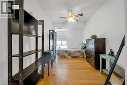 Bedroom featuring ceiling fan and wood-type flooring - 