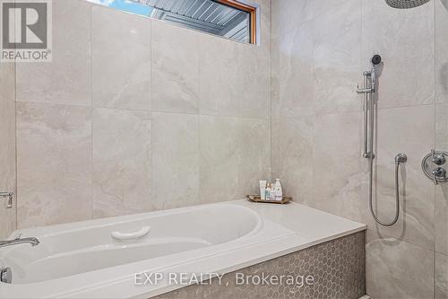 Soaker tub with seamless glass enclosed shower - 586 Pleasant Park Road, Ottawa, ON - Indoor Photo Showing Bathroom