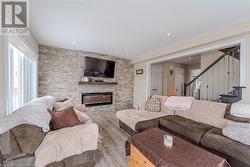 Living room featuring a fireplace and light hardwood / wood-style flooring - 