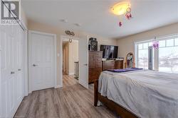 Bedroom featuring light wood-type flooring and a closet - 