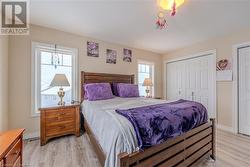 Bedroom featuring light hardwood / wood-style floors and a closet - 