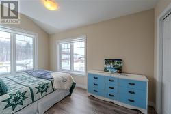 Bedroom featuring lofted ceiling and dark hardwood / wood-style floors - 