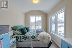 Bedroom featuring light hardwood / wood-style floors and vaulted ceiling - 