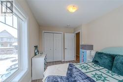 Bedroom with multiple windows, a closet, and light wood-type flooring - 