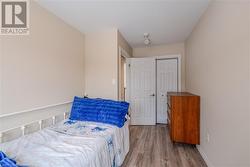 Bedroom with light wood-type flooring and a closet - 