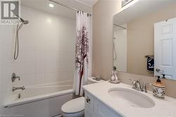 Full bathroom with shower / bath combination with curtain, vanity, and toilet - 