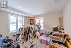 Workout room featuring light hardwood / wood-style floors and a textured ceiling - 