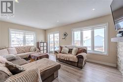 Living room with light hardwood / wood-style floors and a textured ceiling - 