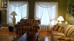 Living room with gleaming hardwood floor - 