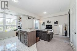 Living room featuring baseboards, visible vents, and light tile patterned flooring - 