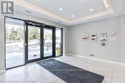 Doorway featuring a raised ceiling, visible vents, french doors, and baseboards - 