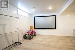 Home theater with light wood finished floors - 