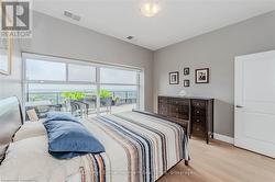 Bedroom featuring light wood-style flooring, visible vents, and baseboards - 