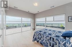 Bedroom with access to outside, visible vents, and wood finished floors - 