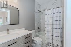 Full bathroom with shower / bath combo, vanity, and toilet - 