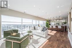 Living area with baseboards, visible vents, dark wood finished floors, and recessed lighting - 