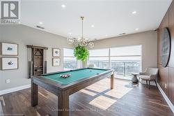 Recreation room with dark wood finished floors, visible vents, and a healthy amount of sunlight - 