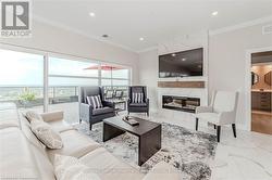 Living room featuring baseboards, ornamental molding, marble finish floor, a fireplace, and recessed lighting - 