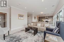 Living room featuring baseboards, visible vents, marble finish floor, crown molding, and recessed lighting - 