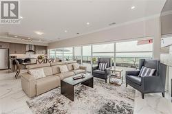 Living area featuring marble finish floor, ornamental molding, visible vents, and recessed lighting - 