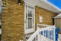 Doorway to property featuring brick siding - 