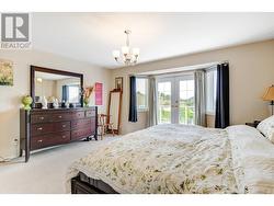 master bedroom with doors out to large deck - 