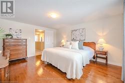 Bedroom with light wood finished floors and baseboards - 