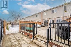 Back of house featuring a residential view, a fenced backyard, and a wooden deck - 