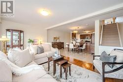 Living area featuring light wood-style floors and stairway - 