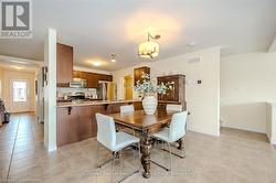 Dining room featuring baseboards, visible vents, and light tile patterned flooring - 