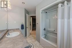 Full bath featuring shower / washtub combination, vanity, and tile patterned floors - 